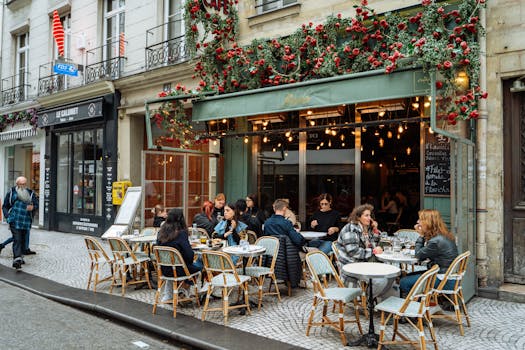 A lively street scene of a Parisian cafe with vibrant outdoor ambiance and dining.